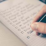 person writing a check list